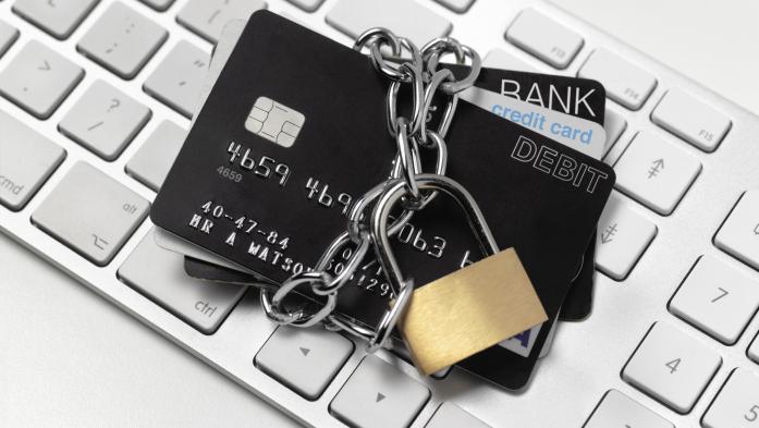 Credit cords with a padlock on top of a keyboard