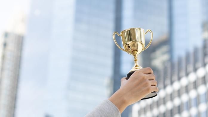 Photo of a person holding a trophy