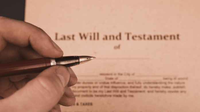 Photo of someone signing a Last Will and Testament