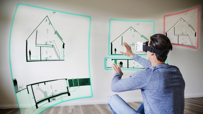 Man with 3D goggles stares at house plans