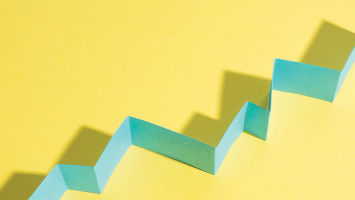 Photo illustration of a blue growth chart on a yellow background
