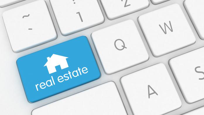 Computer keyboard with a blue real estate key
