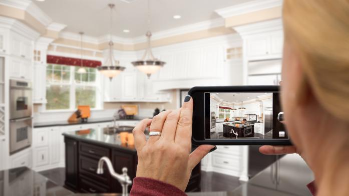 woman with camera in kitchen