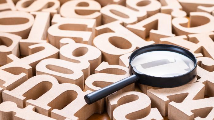 magnifying glass with wooden letters