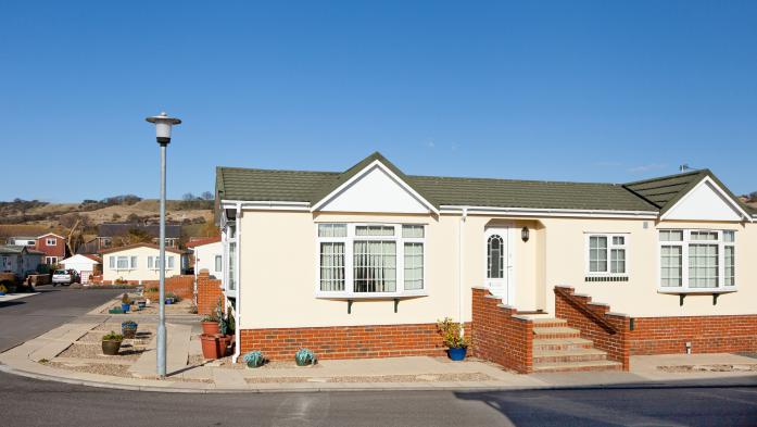 Upscale manufactured home with streetlight and brick entranceway