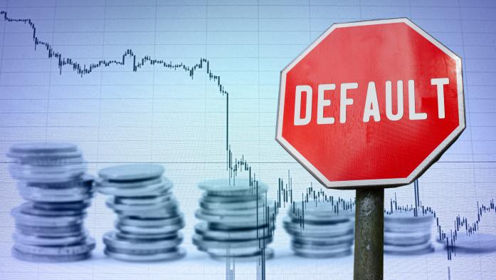 Default sign on economy background of graph and coins