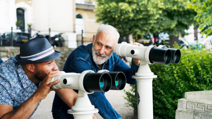 A millennial and boomer look through telescopes